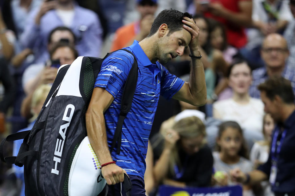Novak Djokovic reacts as he walks off court after retiring due to a should injury during his fourth round match against Stan Wawrinka at the US Open on Sunday night. 