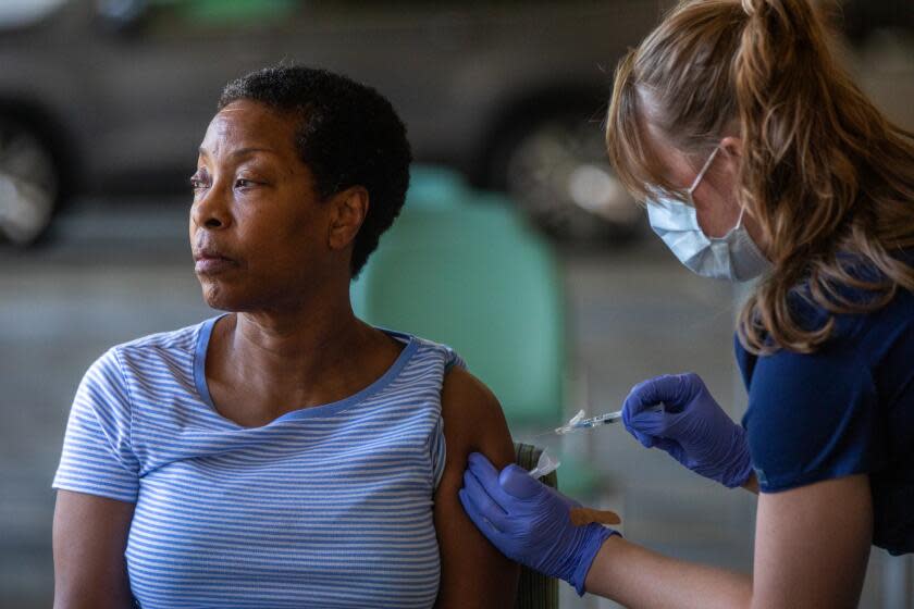 Pasadena, CA - October 12: Denise Fractious, 68, of Pasadena, receives her COVID vaccine during a flu and COVID-19 vaccination clinic at Kaiser Permanente Pasadena on Thursday, Oct. 12, 2023, in Pasadena, CA. (Francine Orr / Los Angeles Times)