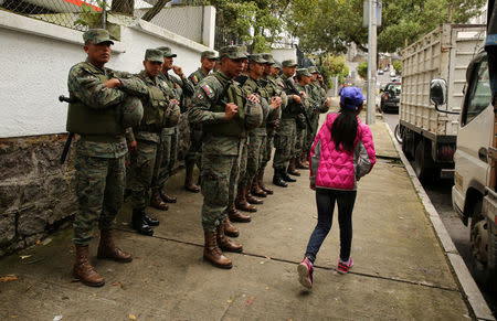 Soldiers stand near the Electoral National Council (CNE) headquarters prior to Sunday presidential election in Quito, Ecuador, April 1, 2017. REUTERS/Mariana Bazo