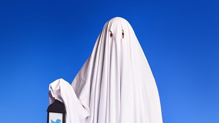 ghost costume holding lantern with twitter bird logo