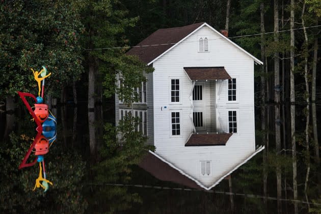 A building flooded by Hurricane Matthew is reflected in the water in Lumberton, North Carolina, on October 10, 2016. <a href="http://www.theatlantic.com/photo/2016/10/the-wreckage-left-behind-by-hurricane-matthew/503687/?utm_source=yahoo" rel="nofollow noopener" target="_blank" data-ylk="slk:See more photos of the hurricane’s aftermath here.;elm:context_link;itc:0;sec:content-canvas" class="link ">See more photos of the hurricane’s aftermath here.</a> (Sean Rayford / Getty)