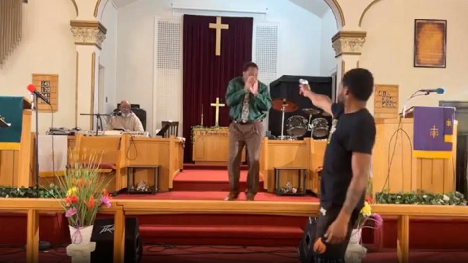 PHOTO: A man pulls a gun during a sermon at Jesus' Dwelling Place Church in North Braddock, Pa., in a screengrab from a video taken on Sunday, May 5, 2024. (Glenn Germany)