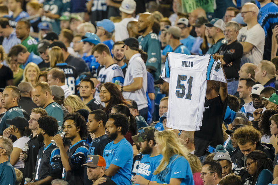 A Carolina Panthers’ fan honors deceased Carolina linebacker and coach Sam Mills by holding up his jersey in the crowd against the <a class="link " href="https://sports.yahoo.com/nfl/teams/philadelphia/" data-i13n="sec:content-canvas;subsec:anchor_text;elm:context_link" data-ylk="slk:Philadelphia Eagles;sec:content-canvas;subsec:anchor_text;elm:context_link;itc:0">Philadelphia Eagles</a> during the first half of an NFL football game in Charlotte, N.C., Thursday, Oct. 12, 2017. The Eagles won 28-23. (AP Photo/Bob Leverone)