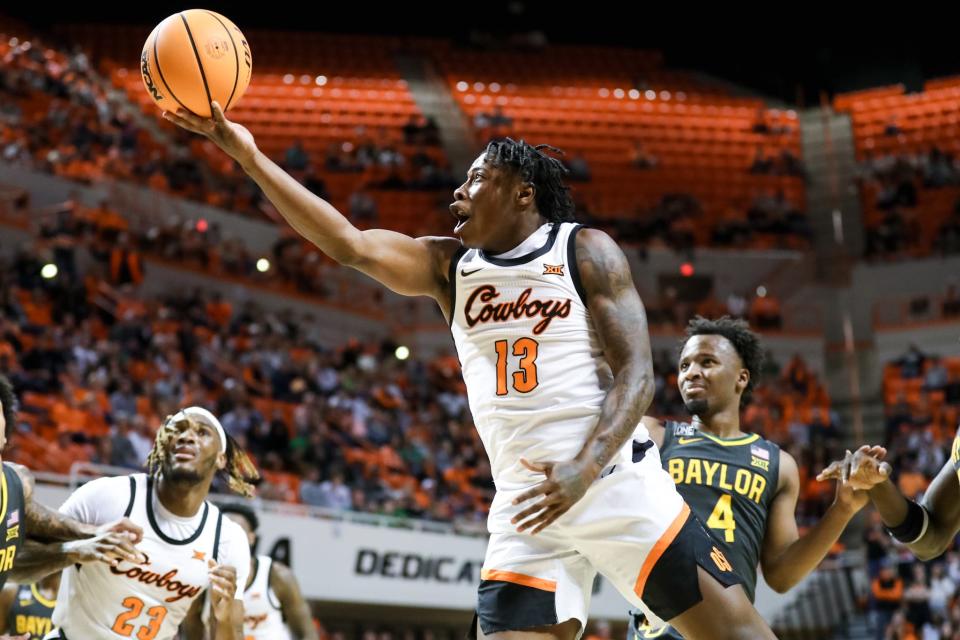 Oklahoma State guard Quion Williams (13) jumps for a layup in the first half during a college basketball game between the Oklahoma State Cowboys (OSU) and the Baylor Bears at Gallagher-Iba Arena in Stillwater, Okla., Monday, Feb. 27, 2023.