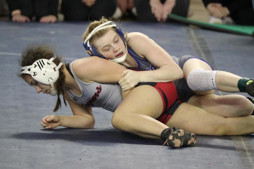 Peyton Hand of Choctaw, top, wrestles Kyrstan Perez of 
Westmoore in the 115-pound semifinal girls match  during the Oklahoma state wrestling tournament at State Fair Arena in Oklahoma City, Friday, Feb. 24, 2023.