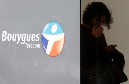 A man checks his mobile device at a French telecom operator Bouygues Telecom store in Paris, France, June 23, 2015. REUTERS/Christian Hartmann