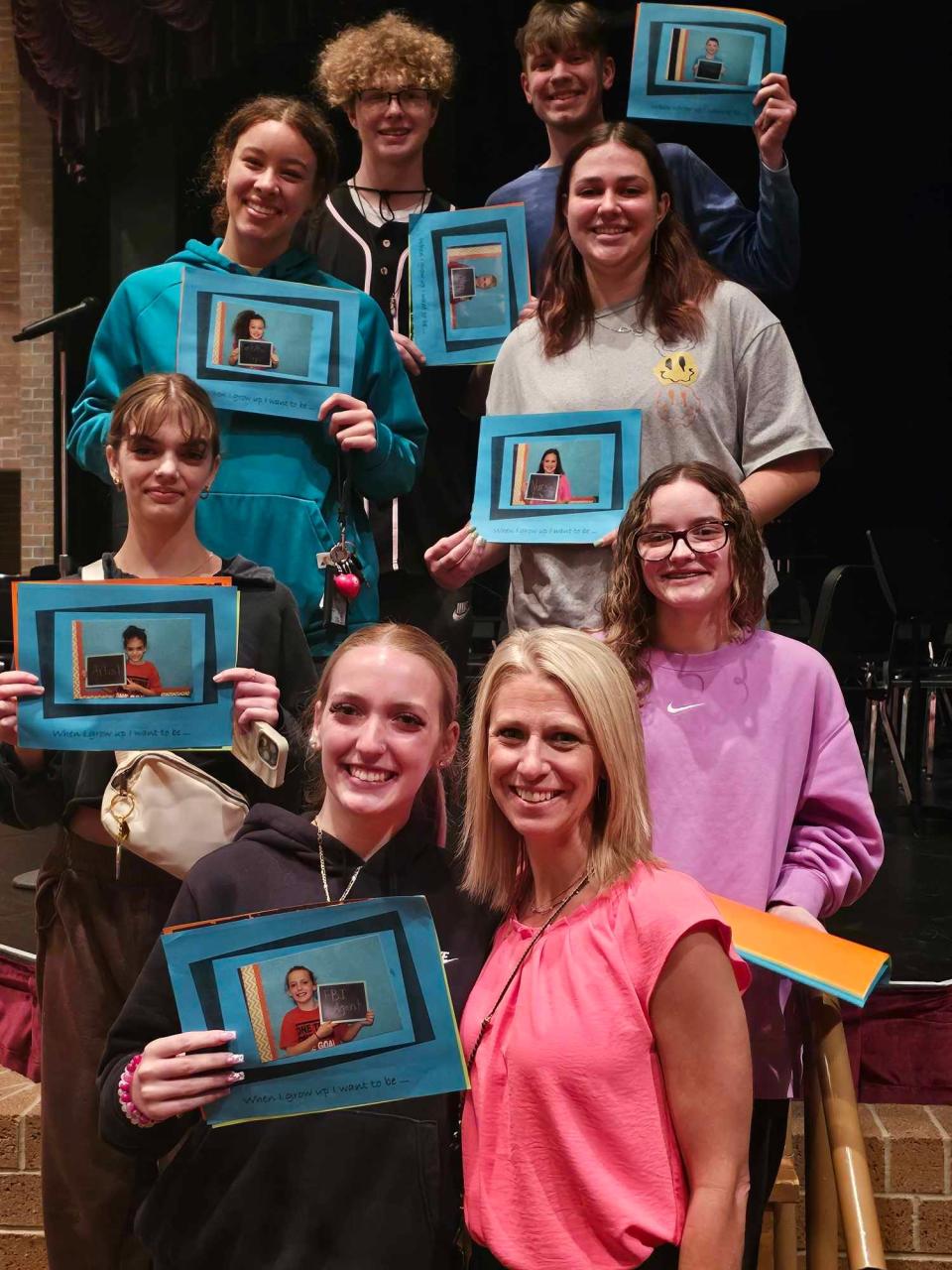 Gorrell Elementary School teacher Melissa Panagopoulos takes a photo with some of her former third graders, who are now seniors at Washington High School. Panagopoulos now teaches second grade at Gorrell.