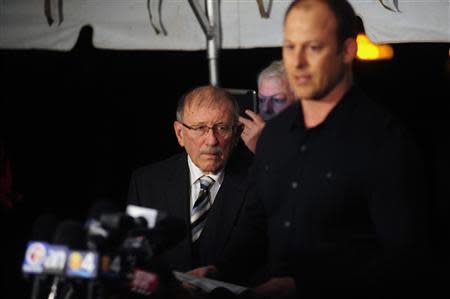 Don Ryce, father of murdered nine-year-old Jimmy Ryce, watches as his son Tim (R) speaks with reporters outside Florida State Prison following the execution of Juan Carlos Chavez in Starke, Florida February 12, 2014. REUTERS/David Manning