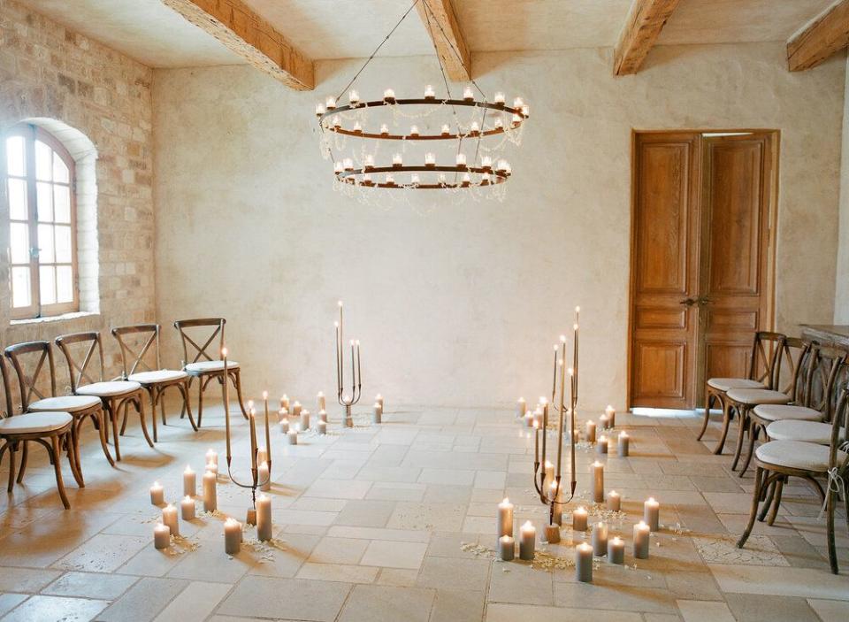 <p>Candles and natural light exude a natural feeling of warmth, romance, and intimacy, and a circular design brings everyone in the room together. A collection of candelabras and pillar candles set the mood for this small ceremony—and yours could follow suit. Use candles of all kinds to create an unconventional wedding altar that feels romantic and sentimental. Trust us: This setup is ideal for a wedding with a limited guest count. </p><p><em>Pictured: Design by <a href="https://www.joyproctor.com/" rel="nofollow noopener" target="_blank" data-ylk="slk:Joy Proctor;elm:context_link;itc:0;sec:content-canvas" class="link ">Joy Proctor</a>. </em></p>