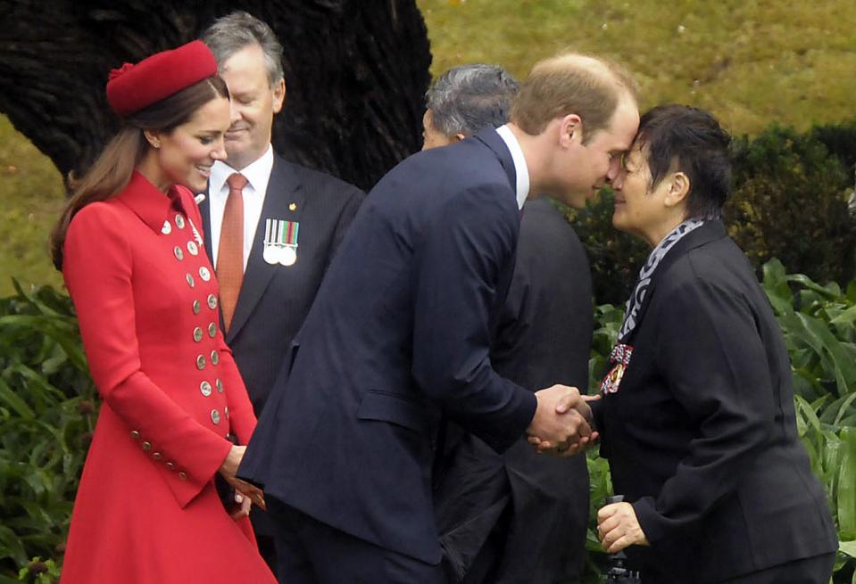 Britain's Prince William (C) is watched by his wife Catherine, Duchess of Cambridge, as he receives a Maori welcome known as a "Hongi" at a traditional Maori Powhiri Ceremonial Welcome at Government House in Wellington April 7, 2014 in this handout provided by Woolf Crown Copyright. The Prince and his wife Kate are undertaking a 19-day official visit to New Zealand and Australia with their son George. REUTERS/Woolf Crown Copyright/Handout via Reuters (NEW ZEALAND - Tags: ROYALS ENTERTAINMENT POLITICS IMAGES OF THE DAY) NO SALES. NO ARCHIVES. FOR EDITORIAL USE ONLY. NOT FOR SALE FOR MARKETING OR ADVERTISING CAMPAIGNS. ATTENTION EDITORS - THIS IMAGE HAS BEEN SUPPLIED BY A THIRD PARTY. REUTERS IS UNABLE TO INDEPENDENTLY VERIFY THE AUTHENTICITY, CONTENT, LOCATION OR DATE OF THIS IMAGE. THIS PICTURE WAS PROCESSED BY REUTERS TO ENHANCE QUALITY. AN UNPROCESSED VERSION WILL BE PROVIDED SEPARATELY. MANDATORY CREDIT