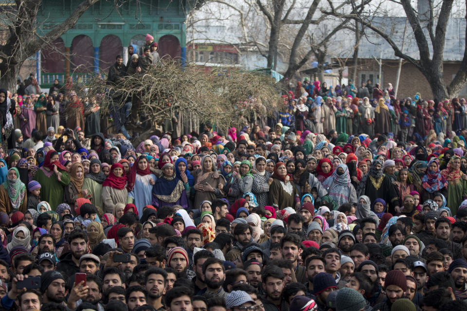 Kashmiri villagers watch the joint funeral procession of four rebels in Tral, south of Srinagar, Indian controlled Kashmir, Saturday, Dec. 22, 2018. A gunbattle between Indian troops and Kashmiri rebels early Saturday left six militants dead and triggered a new round of anti-India protests in the disputed Himalayan region. (AP Photo/Dar Yasin)