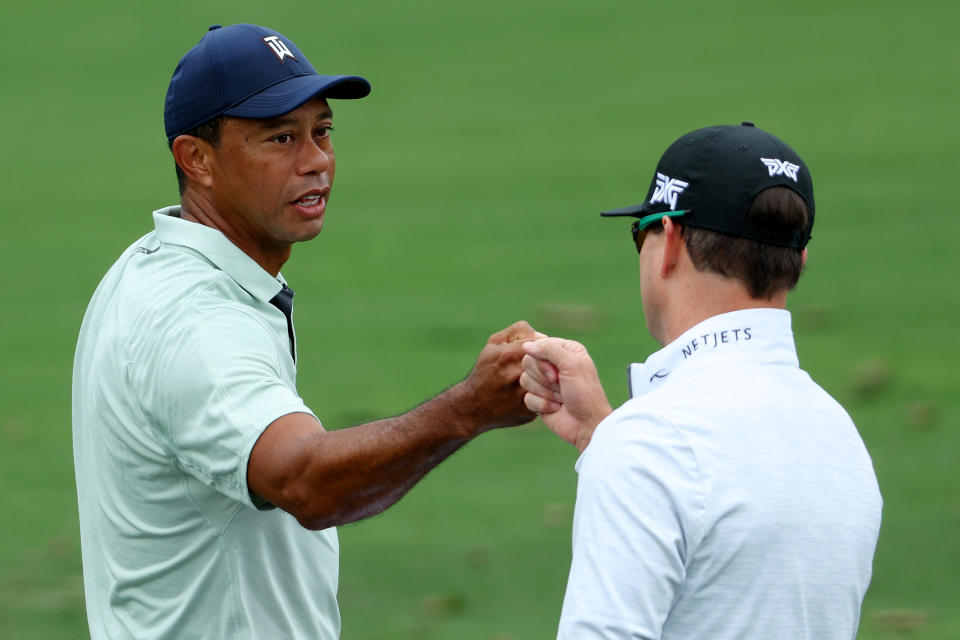 Tiger Woods (pictured left) greets Zach Johnson (pictured right) on the range during a practice round.