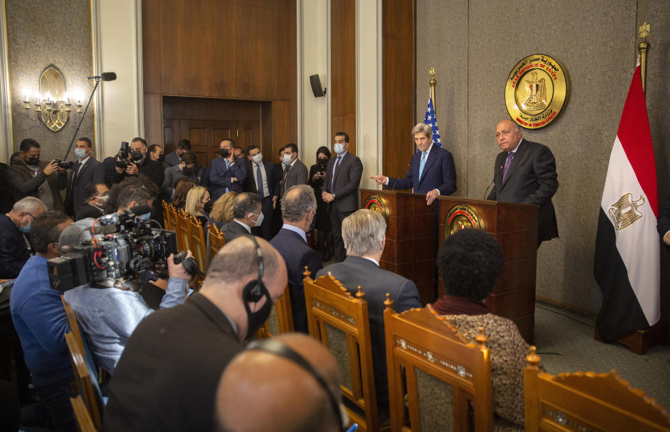 U.S. climate envoy John Kerry, rear center, and Egyptian Foreign Minister Sameh Shoukry, right, speak during a press conference at the foreign ministry headquarters in Cairo, Egypt, Monday, Feb. 21, 2022. (AP Photo/Amr Nabil)