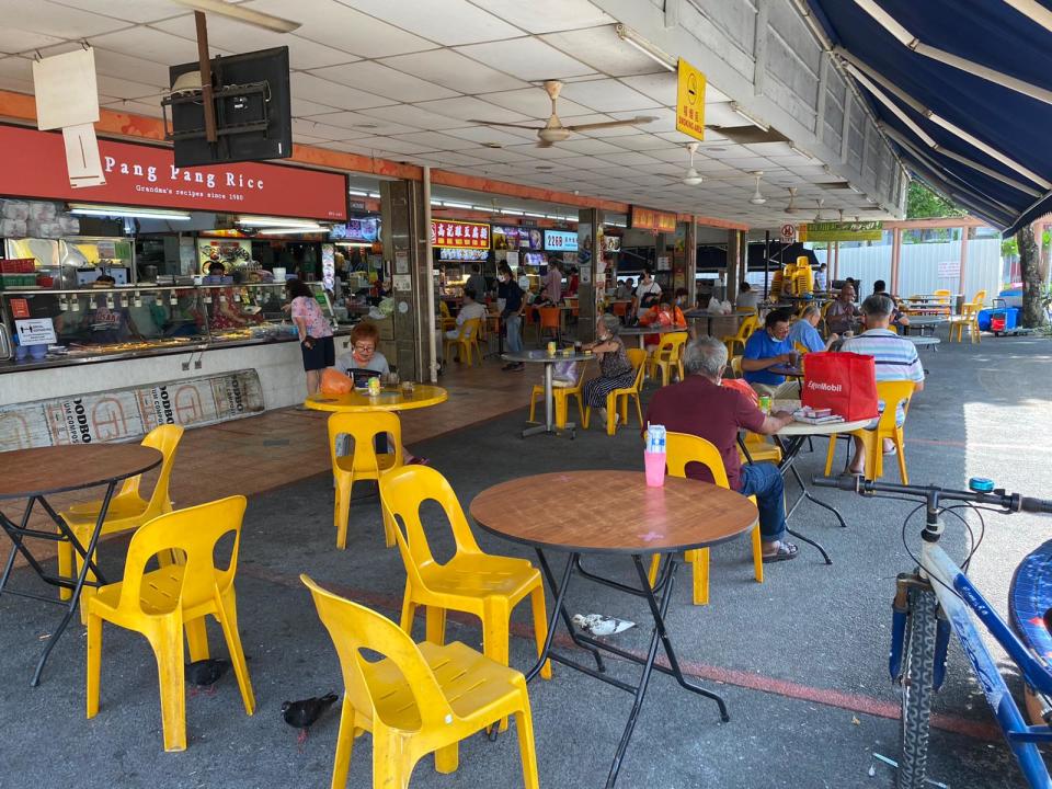 Guests sit at round tables eating and drinking at a cafe at Ang Mo Kio St 22. (PHOTO: Chia Han Keong/Yahoo News Singapore)