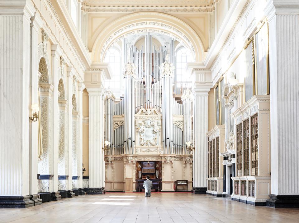 Him, 2001, kneels in the Long Library.