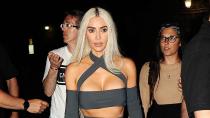 <p>brings her bold blonde hair and skin-baring style sense to the weekend's festivities in her favorite fashion flex — pantaboots! — and a cutout crop top with attached sleeves (both Dolce & Gabbana) worn to toast the happy couple<a href="https://people.com/style/kardashian-jenners-show-off-unique-takes-on-gothic-glam-for-kourtney-and-travis-barkers-wedding/" rel="nofollow noopener" target="_blank" data-ylk="slk:at their welcome dinner;elm:context_link;itc:0;sec:content-canvas" class="link "> at their welcome dinner</a>. </p>