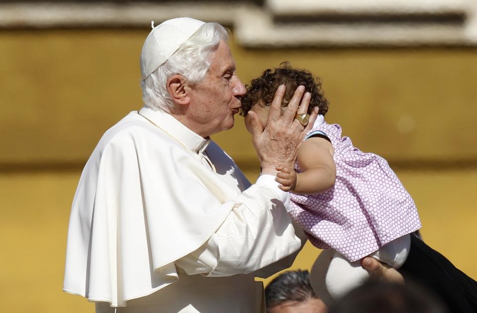 Pope Benedict XVI kisses a baby at the end of his weekly audience in Saint Peter's Square at the Vatican October 12, 2011 (Reuters)