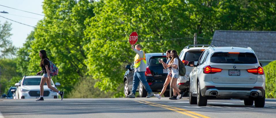 Students on their way to school cross Bolton St. as bus drivers on strike picketed outside the Whitcomb Middle School and then high school  in Marlborough, May 8, 2023.