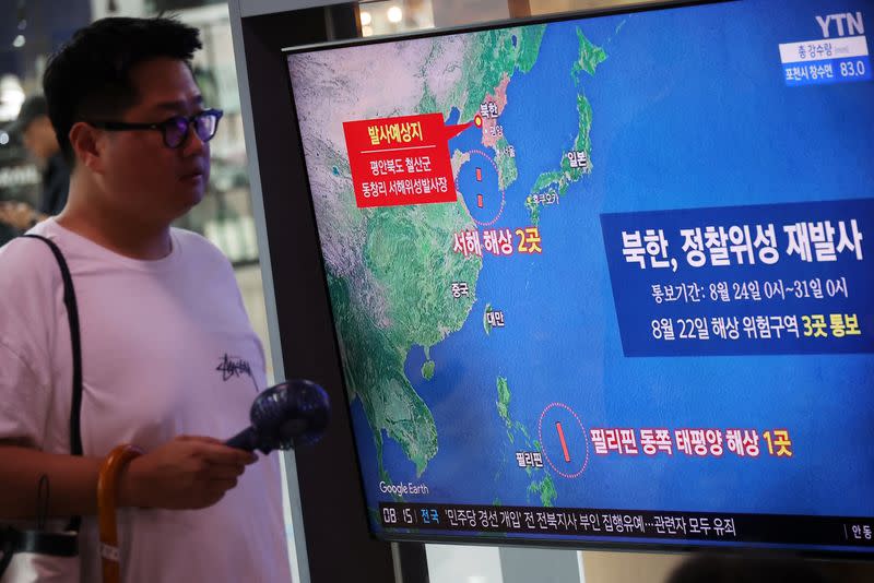 TV broadcasting a news report on North Korea firing a space rocket, at a railway station in Seoul