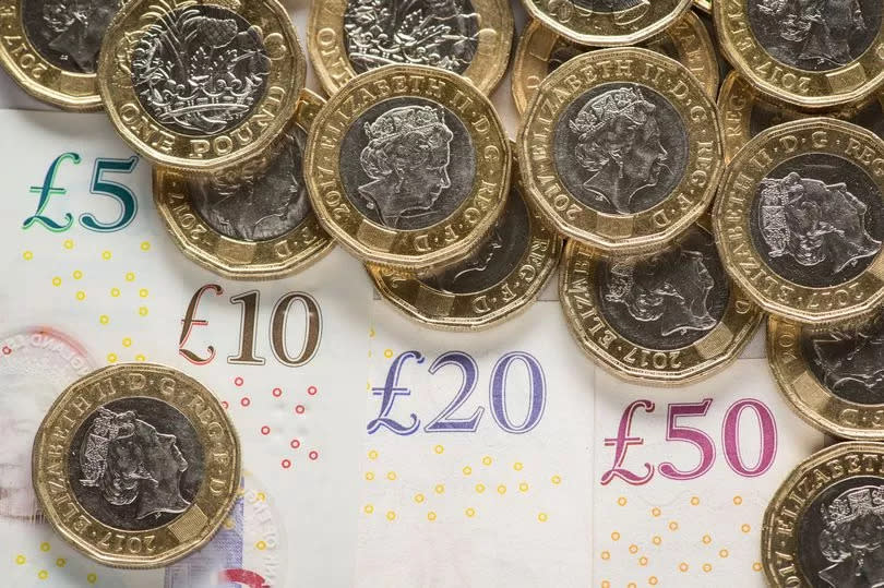 Pile of pound coins and pound notes