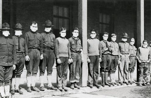 <span class="caption">Medics in masks at a US army hospital in 1918.</span> <span class="attribution"><a class="link " href="https://www.shutterstock.com/image-photo/medical-men-wore-masks-avoid-flu-248206198" rel="nofollow noopener" target="_blank" data-ylk="slk:Shutterstock/Everett Historical;elm:context_link;itc:0;sec:content-canvas">Shutterstock/Everett Historical</a></span>