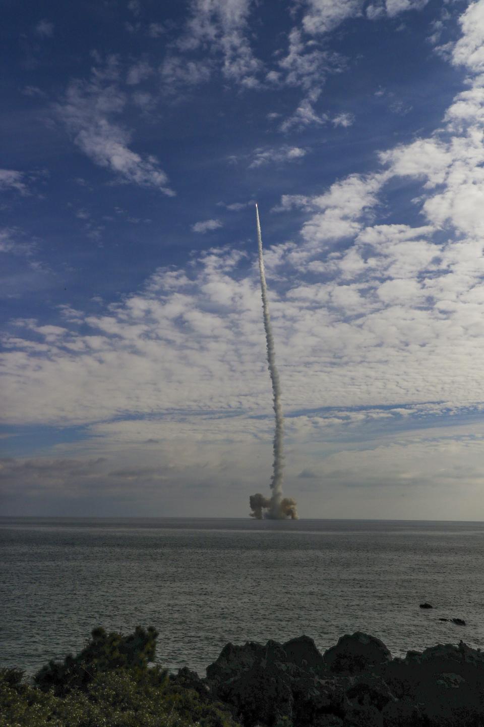 In this photo provided by South Korea Defense Ministry, the third test flight of solid-fuel space rocket is launched from a barge in waters near Jeju Island, South Korea, Monday, Dec. 4, 2023. (South Korea Defense Ministry via AP)