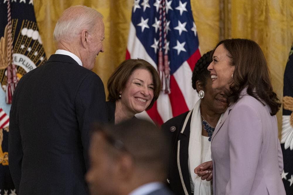 President Joe Biden, Sen. Amy Klobuchar, D-Minn., center, and Vice President Kamala Harris, right, share a laugh after the president signed H.R. 1652, the VOCA Fix to Sustain the Crime Victims Fund Act of 2021, in the East Room of the White House in Washington, Thursday, July 22, 2021. (AP Photo/Andrew Harnik)