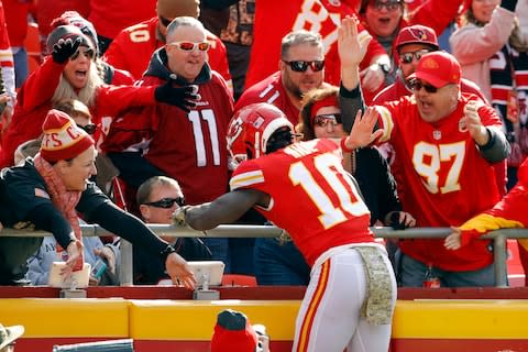 Kansas City Chiefs wide receiver Tyreek Hill (10) celebrates a touchdown against the Arizona Cardinals with fans during the first half of an NFL football game in Kansas City - Credit: AP Photo/Charlie Riedel