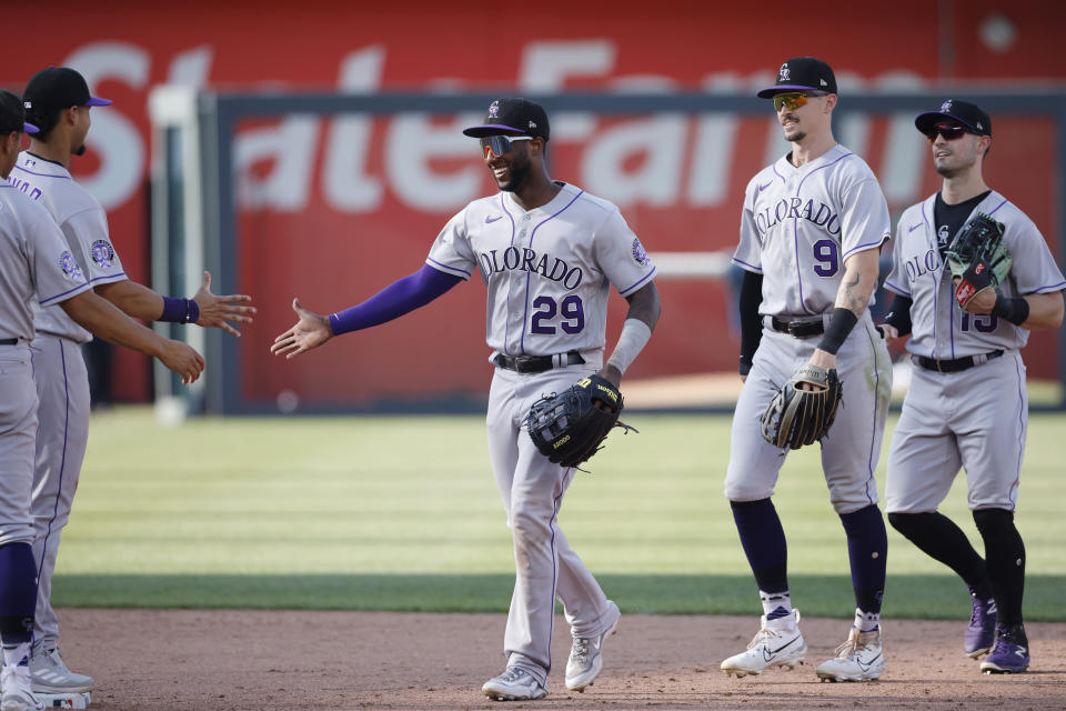 Colorado Rockies' Jurickson Profar (29) Brenton Doyle (9) and Randal Grichuk (15) celebrate with teammates after a baseball game against the Kansas City Royals in Kansas City, Mo., Saturday, June 3, 2023. (AP Photo/Colin E. Braley)