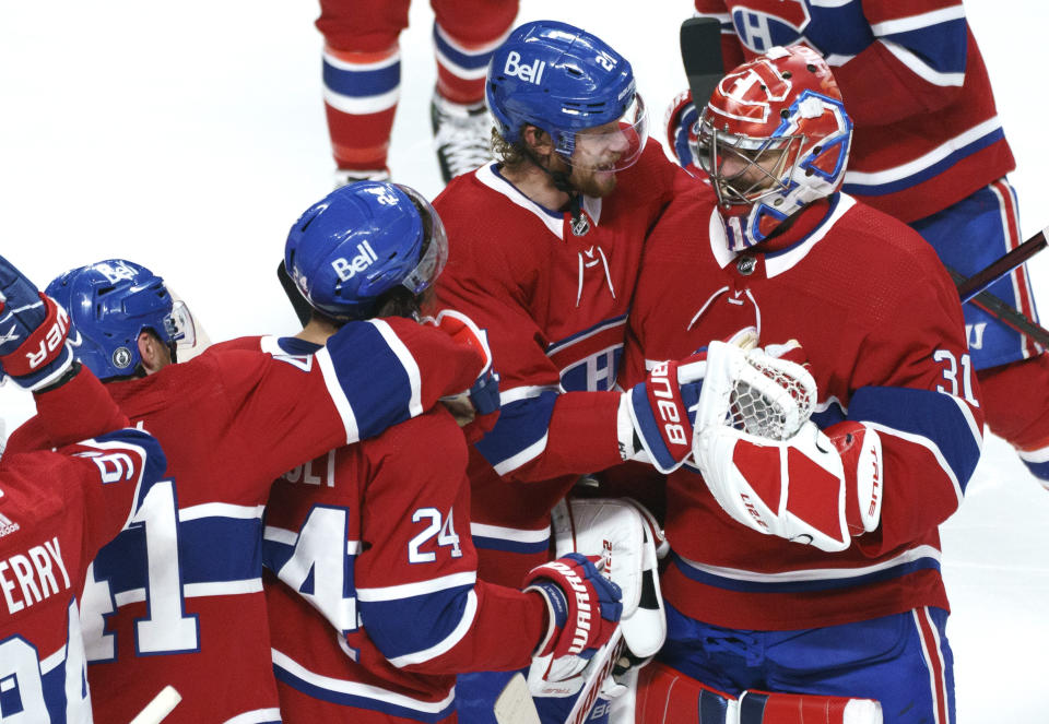 Montreal Canadiens' Eric Staal (21) celebrates the team's win with goaltender Carey Price following overtime in Game 6 of an NHL hockey Stanley Cup semifinal playoff series against the Vegas Golden Knights Thursday, June 24, 2021 in Montreal. (Paul Chiasson/The Canadian Press via AP)