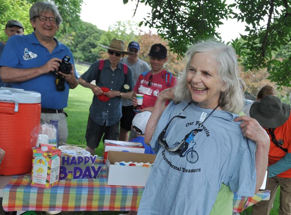 Quincy Environmental Treasures Program founder Sally Owen, of Quincy, displays a T-shirt presented to her on her 75th birthday honoring her as "Our favorite environmental treasure" following a tour of Merrymount Park led by Quincy Mayor Thomas Koch.