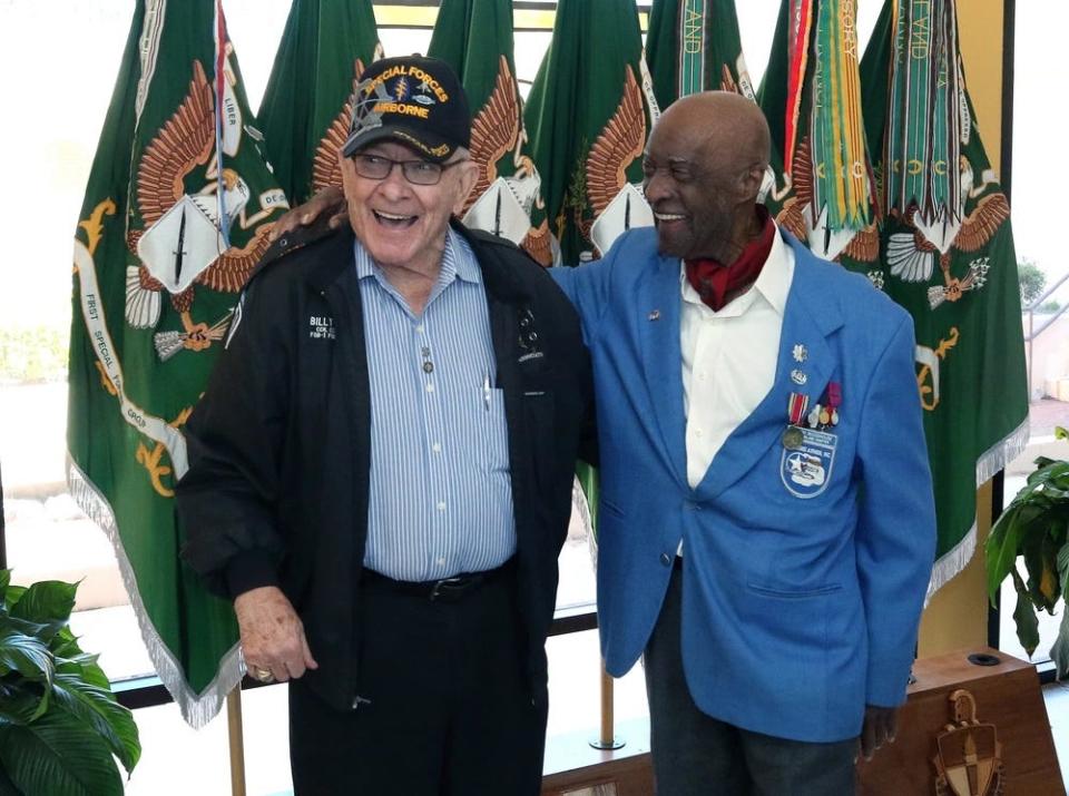 Retired Sgt. Maj. William “Billy” Waugh, far leight  shares a laugh with retired Lt. Col.  Enoch Woodhouse II, a Tuskegee Airman who spoke at the at the U.S. Army John F. Kennedy Special Warfare Center and School auditorium following a Feb. 25, 2019, Black History Month observance.