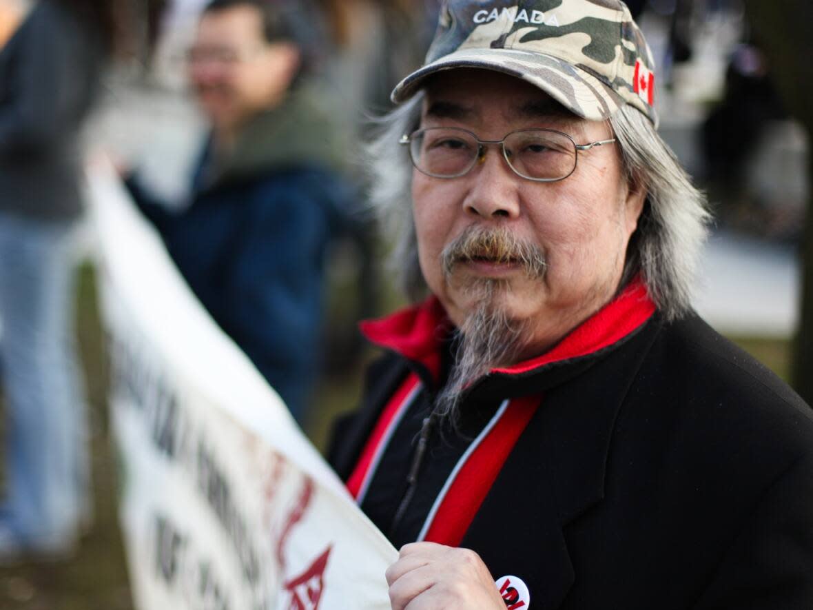 Sid Chow Tan is seen at an anti-racism rally in Vancouver in March 2013. The longtime community filmmaker, activist and artist has died at the age of 73. (David P. Ball/CBC - image credit)