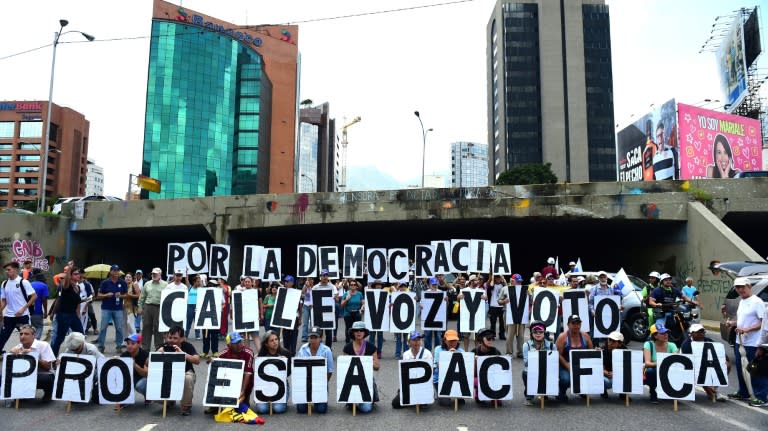 Opposition activists protest in Caracas on August 12, 2017