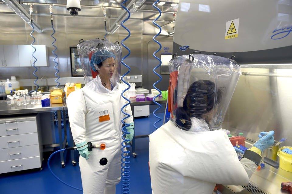 Image: Virologist Shi Zheng-li, left, works with her colleague in the P4 lab of Wuhan Institute of Virology in Wuhan in central China's Hubei province. (Feature China / Barcroft Media via Getty Images file)