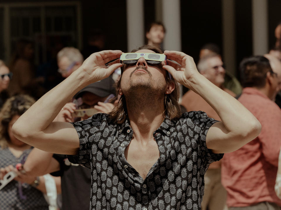 A viewer of the solar eclipse looks to the sky at Main Street Garden Park in Dallas, Texas on April 8, 2024.<span class="copyright">Jake Dockins for TIME</span>