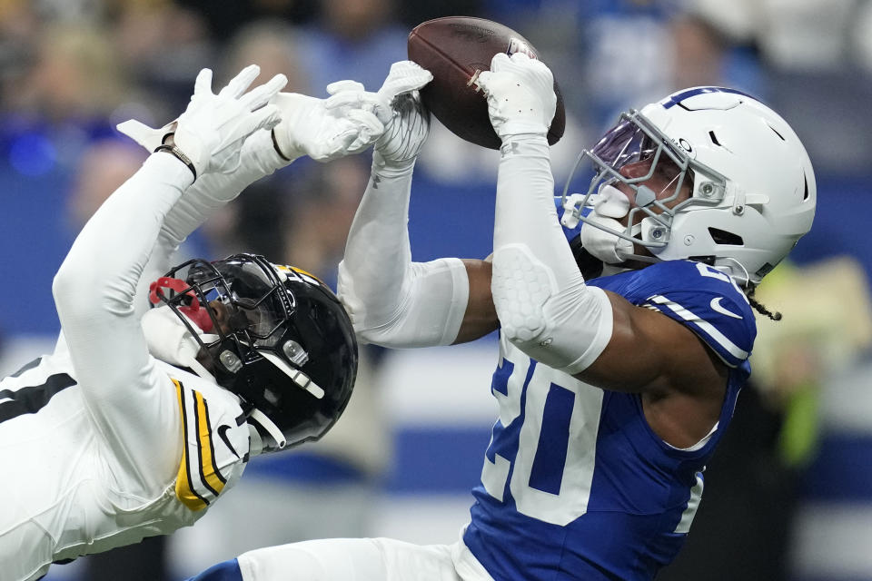 Indianapolis Colts safety Nick Cross (20) intercepts a pass intended for Pittsburgh Steelers wide receiver George Pickens (14) during the first half of an NFL football game in Indianapolis Saturday, Dec. 16, 2023. (AP Photo/Michael Conroy)