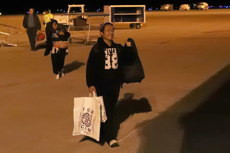 Wimber Htoo and Htoo Lwae Say walk off the plane at Garden City Regional Airport in Garden City, Kansas, U.S., February 15, 2018. REUTERS/Adam Shrimplin