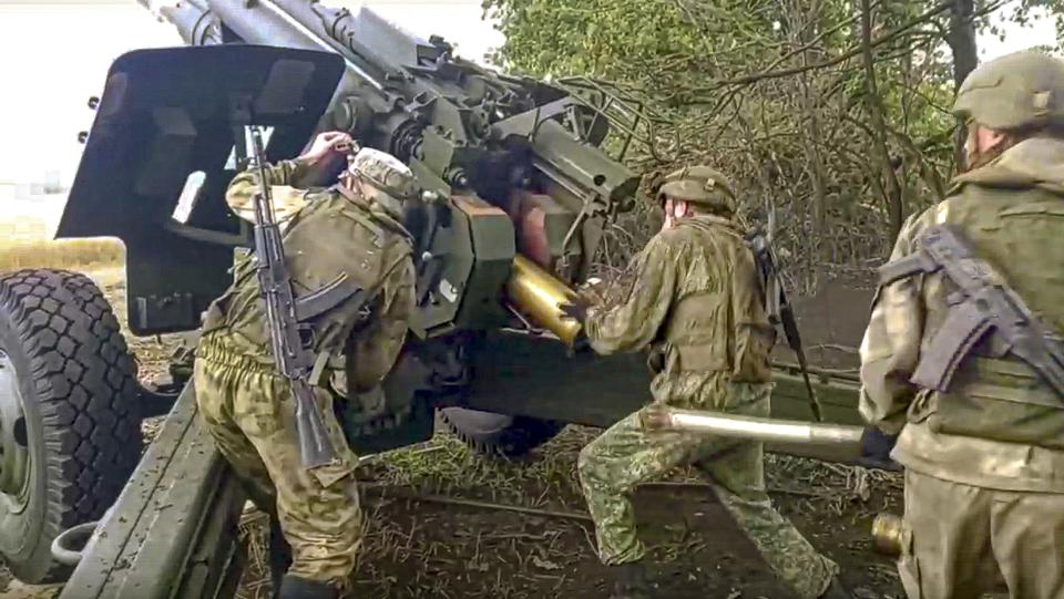 FILE - In this photo released by Russian Defense Ministry Press Service on Sept. 10, 2022, Russian soldiers prepare to fire from Msta-B 152.4 mm howitzer from their position at an undisclosed location in Ukraine. A day after the referendums were announced, Putin on Wednesday Sept. 21, 2022, ordered a partial mobilization of reservists to bolster his forces in Ukraine. (Russian Defense Ministry Press Service via AP, File)