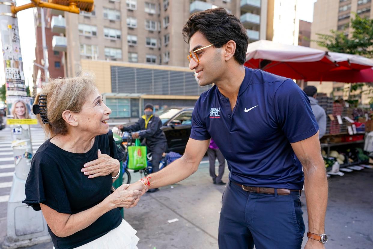 Attorney Suraj Patel, right, speaks to a voter while campaigning, Tuesday, Aug. 16, 2022, in the Upper East Side neighborhood of Manhattan in New York. Patel is running against Rep. Carolyn Maloney and Rep. Jerry Nadler in New York's 12th Congressional District Democratic primary which will be held on Tuesday, Aug. 23, 2022. (AP Photo/Mary Altaffer)