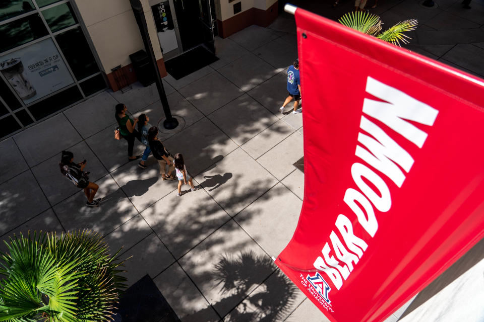 People walk through campus at the University of Arizona in Tucson on Oct. 8, 2022.