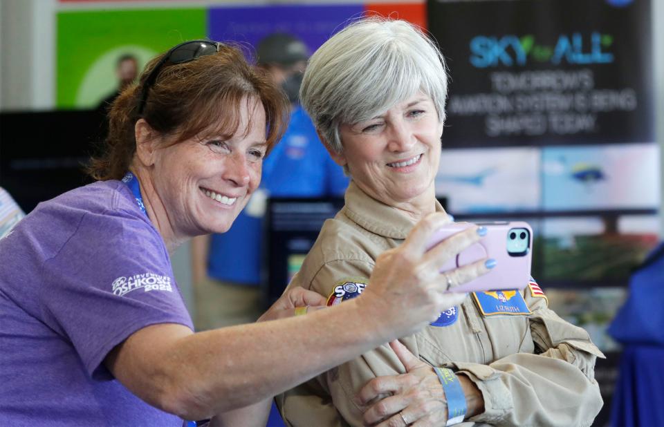 Aileen Watkins, of Palm City, Florida, left, takes a selfie with pilot and author Liz Ruth in the NASA building on Monday during EAA AirVenture Oshkosh 2022,.