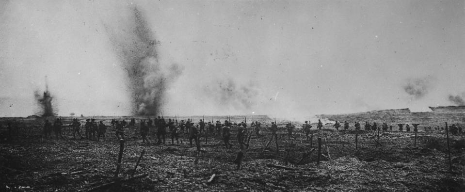 <p>Canadian soldiers are spotted advancing through German barbed wire as shells rain down during the Battle of Vimy Ridge in April 1917. Photo from Library and Archives Canada. </p>