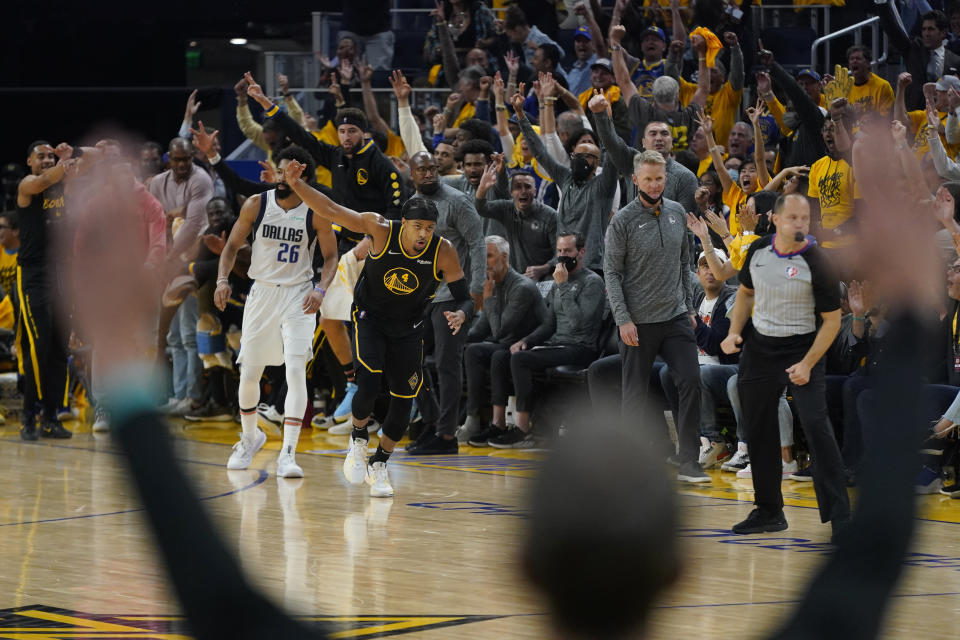 Golden State Warriors guard Moses Moody (4) celebrates after shooting a 3-point basket against the Dallas Mavericks during the first half of Game 5 of the NBA basketball playoffs Western Conference finals in San Francisco, Thursday, May 26, 2022. (AP Photo/Jeff Chiu)