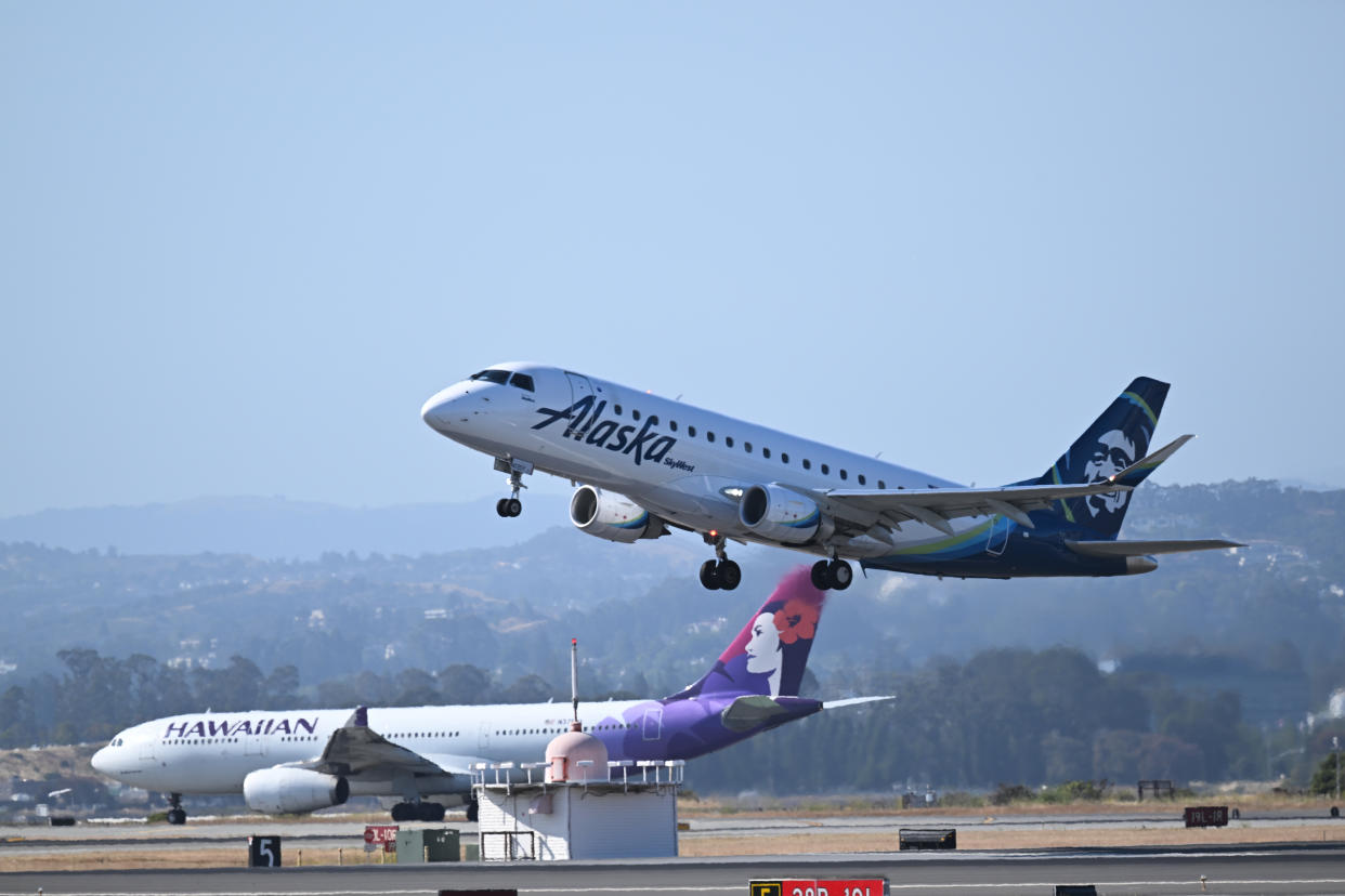 Alaska and Hawaiian Airlines planes takeoff at the same time from San Francisco International Airport.