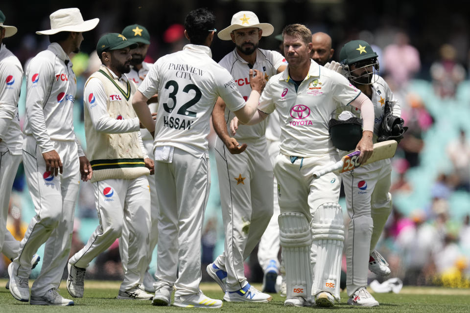 Australia's David Warner, third right, is congratulated by Pakistan's players as he walks off the field on the fourth day of their cricket test match in Sydney, Saturday, Jan. 6, 2024. (AP Photo/Rick Rycroft)