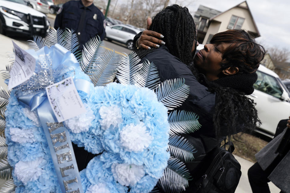 Mourners hug after a funeral for Michigan State University shooting victim Arielle Anderson in Detroit, Tuesday, Feb. 21, 2023. Anderson, Alexandria Verner and Brian Fraser and were killed and several other students injured after a gunman opened fire on the campus of Michigan State University. (AP Photo/Paul Sancya)