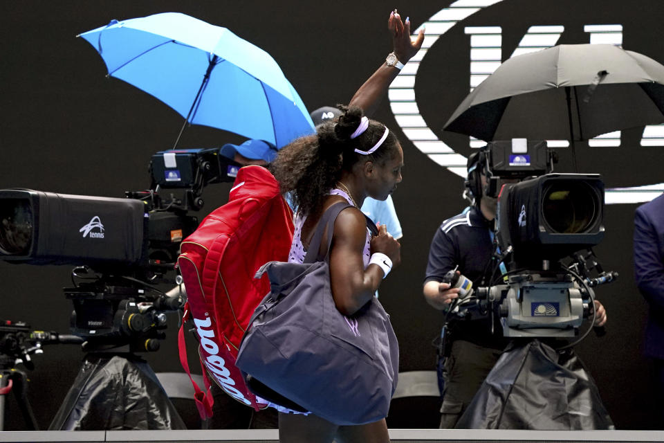 FILE - In this Jan. 24, 2020, file photo, Serena Williams waves as she leaves Rod Laver Arena after a third round loss to China's Wang Qiang at the Australian Open tennis championship in Melbourne, Australia. (AP Photo/Lee Jin-man, File)