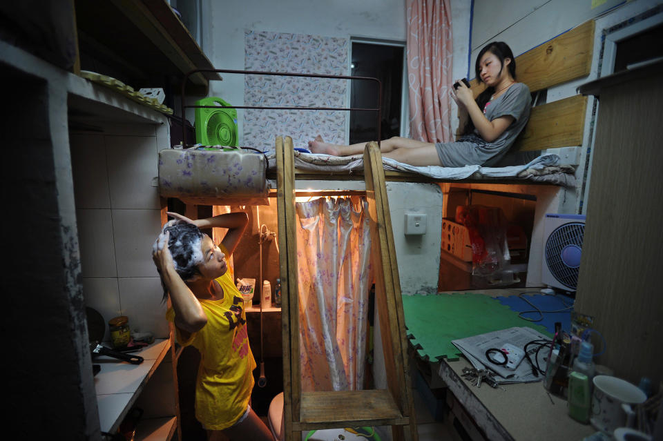 A girl chats to her roommate as she washes her hair (Rex)