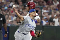 Chicago Cubs third baseman Christopher Morel (5) throws to first to complete a double play against the Arizona Diamondbacks during the third inning of a baseball game Wednesday, April 17, 2024, in Phoenix. (AP Photo/Darryl Webb)